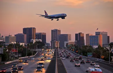 San Diego, California, USA - October 8, 2015: British Airways Boeing 777 flying over crowded freeway to land at Lindberg Field San Diego International Airport.